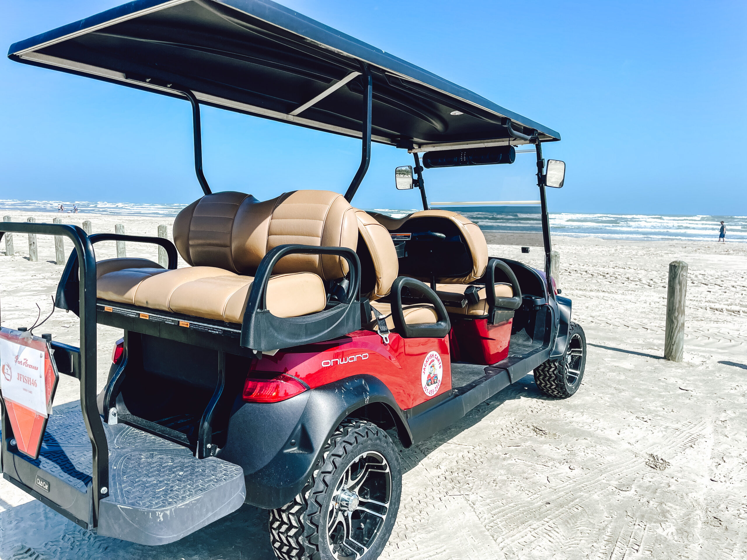 jackfish signature golf cart parked at the beach in port aransas, texas